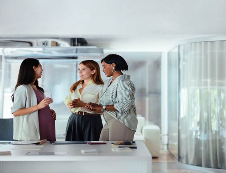 Pregnant women talking at work - Pregnancy Discrimination